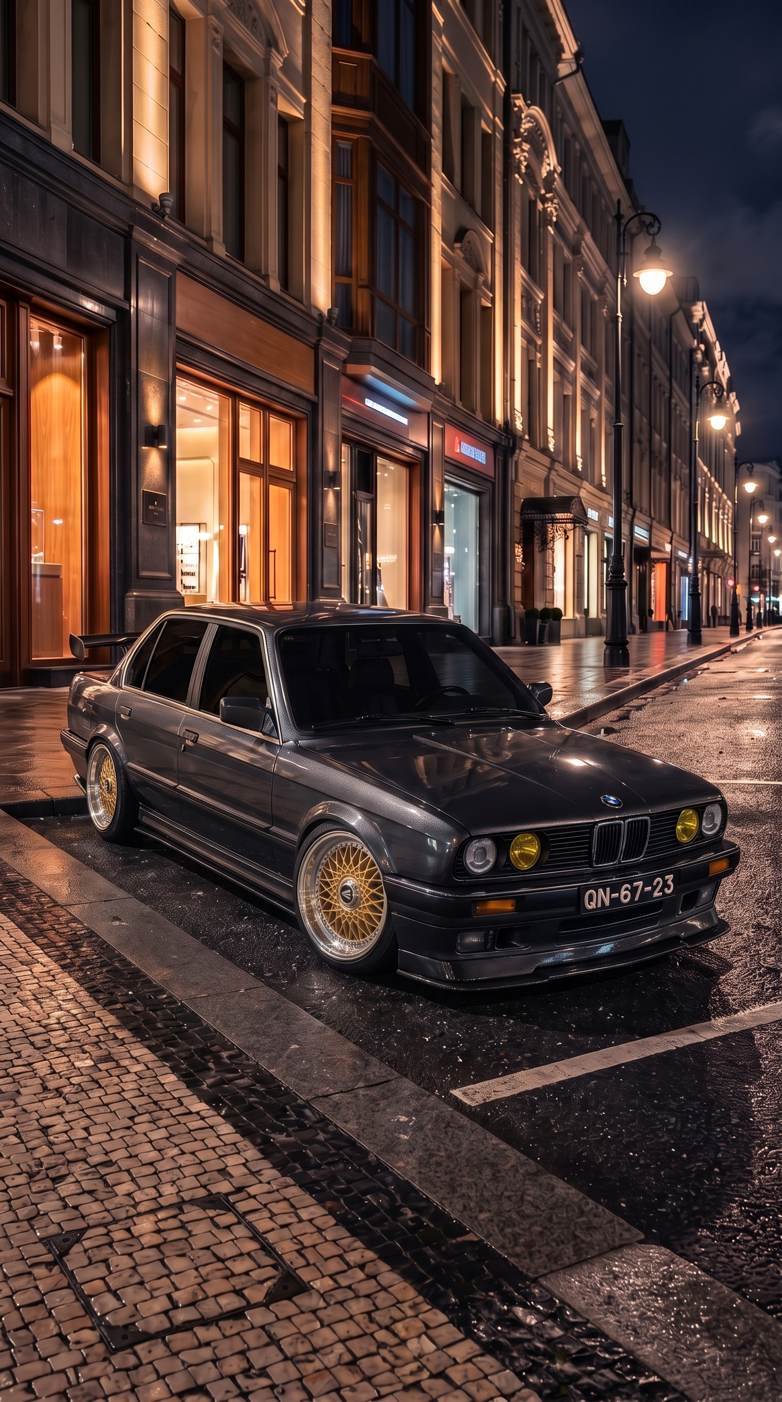 1985 BMW 3 Series with Enkei ENKEI92 15" · Gold, Ride height −100 mm, 90% tint, Custom metallic paint, Shot in the city lights, Front lip splitter, Side skirts, Rear diffuser, 90s pedestal spoiler